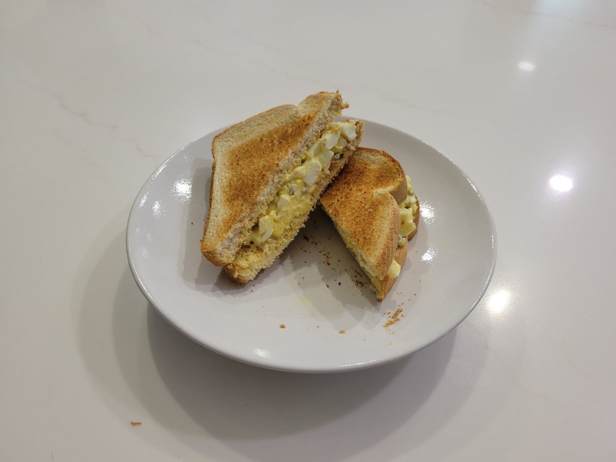 Egg salad sandwich on toasted white bread, cut on the diagonal