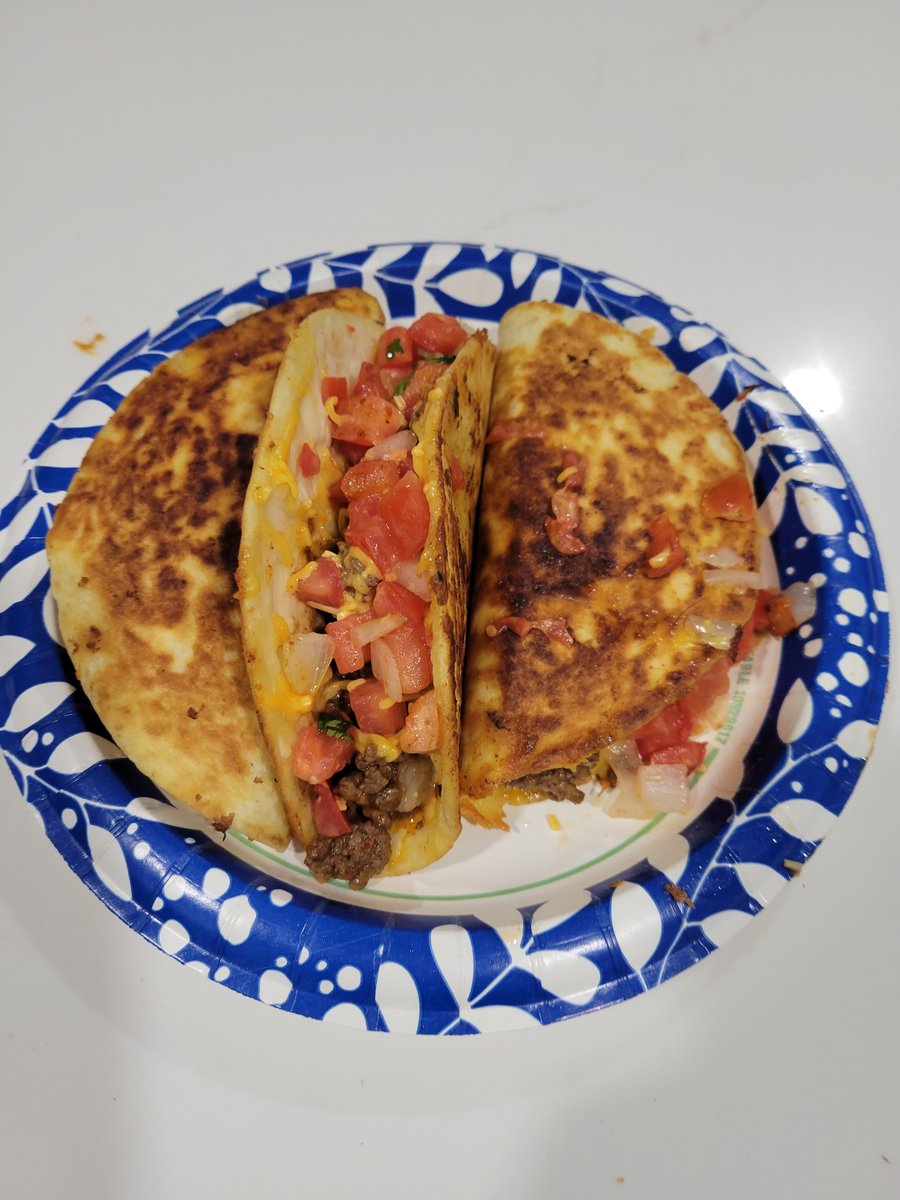 A crispy pan-fried taco with melted cheese oozing out the edges